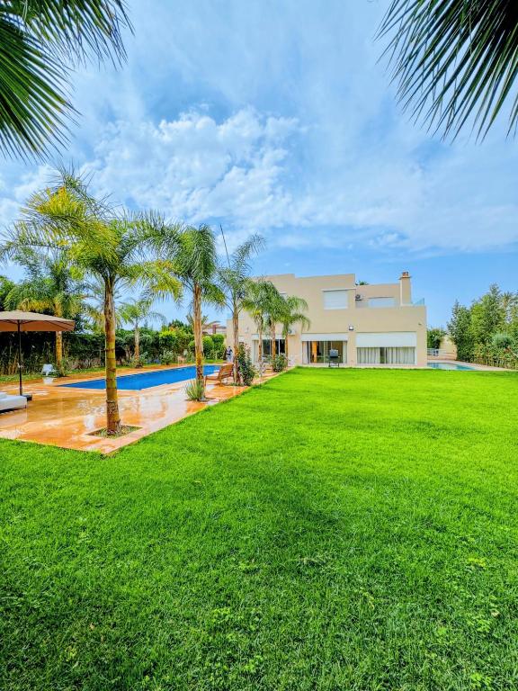 a large yard in front of a house with a pool at Villa Marrakech, 15 min from center, Disco, Hammam in Marrakesh