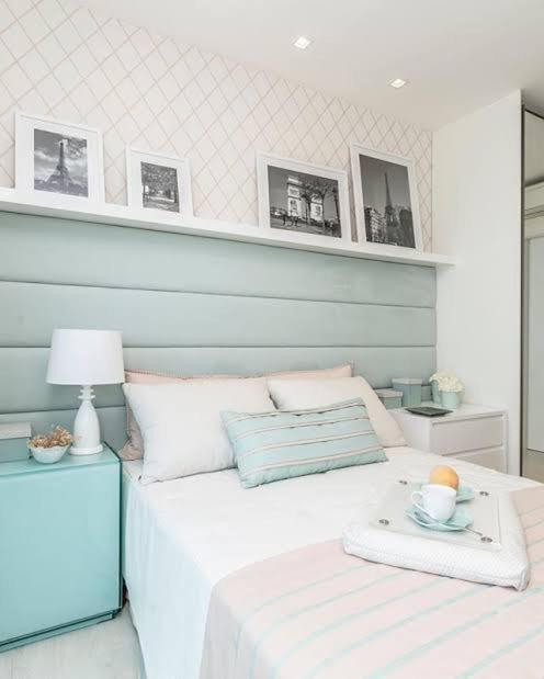 a bedroom with a bed with a table and a lamp at Mateus praia casa in Búzios