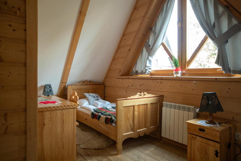 a bedroom with a bed and a window at BIAŁY PUCH in Zakopane