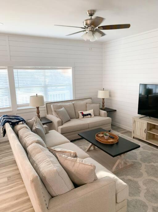a living room with a couch and a tv at Coastal Condos on the Marsh 6A in Dauphin Island