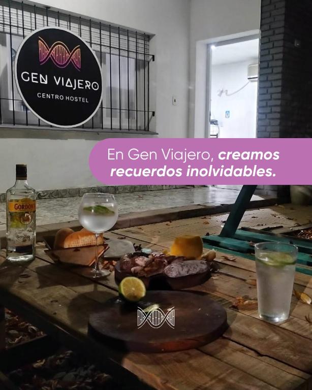 a table with some drinks and some food on it at Gen Viajero Hostel in Merlo