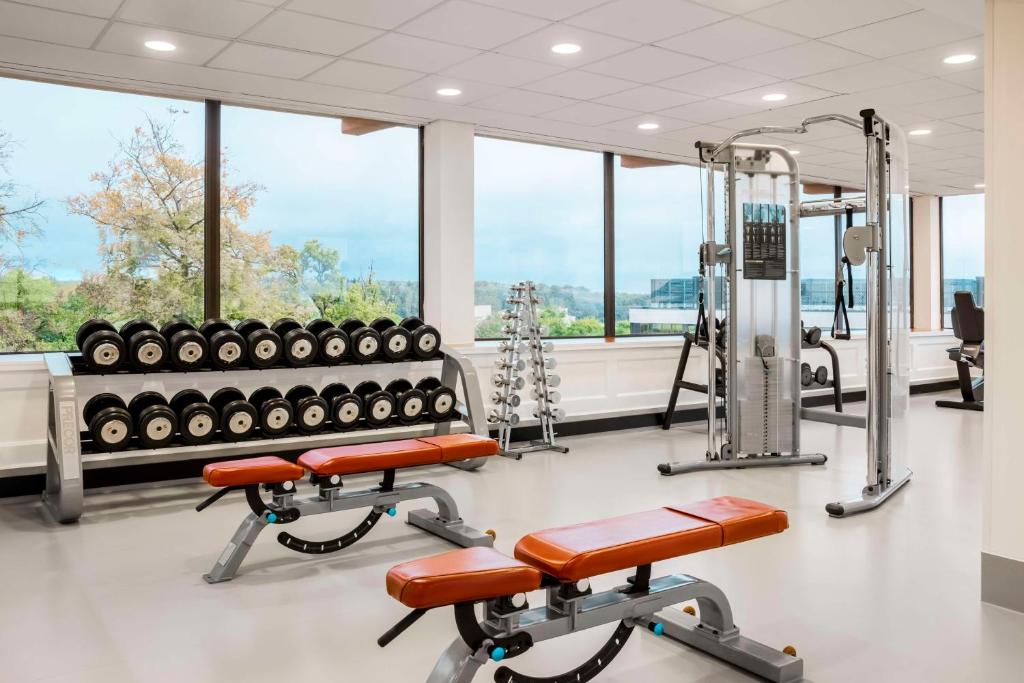 a gym with two exercise equipment and windows at NH Luxembourg Airport in Luxembourg