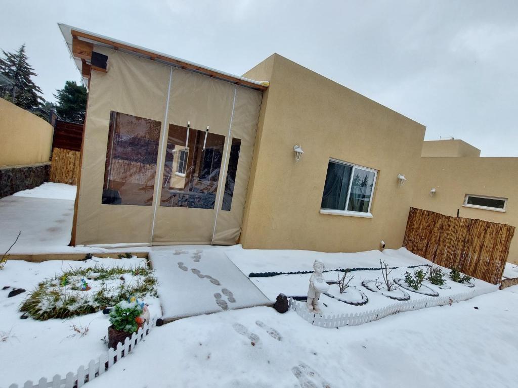 a house covered in snow in front of a house at El Room Zimmer in El-Rom