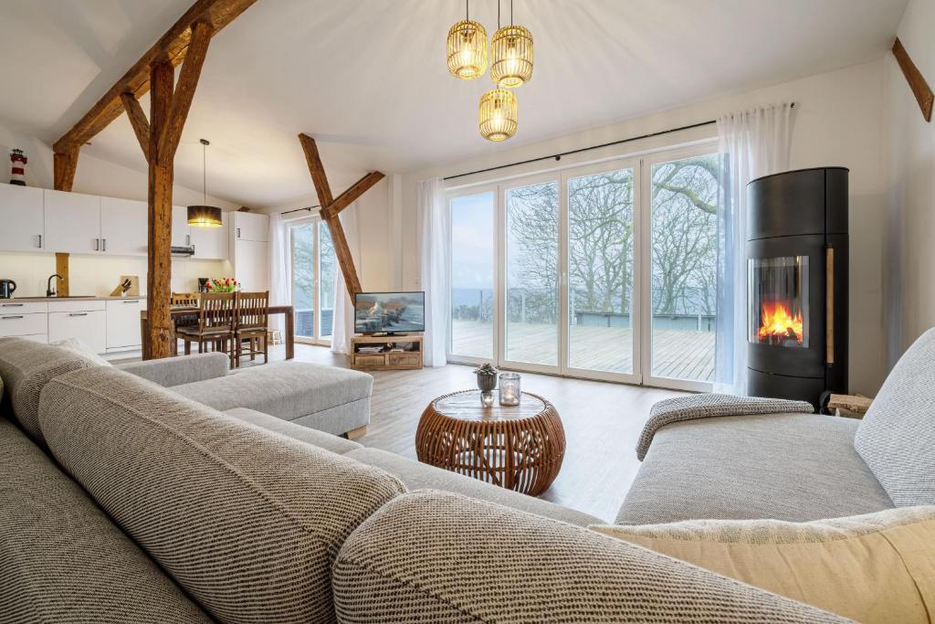 a living room with a couch and a fireplace at Westscheune am Mühlendamm in Steinbergkirche