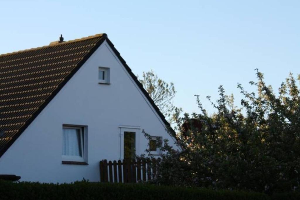 a white house with a brown roof at Fewo Janssen in Borkum