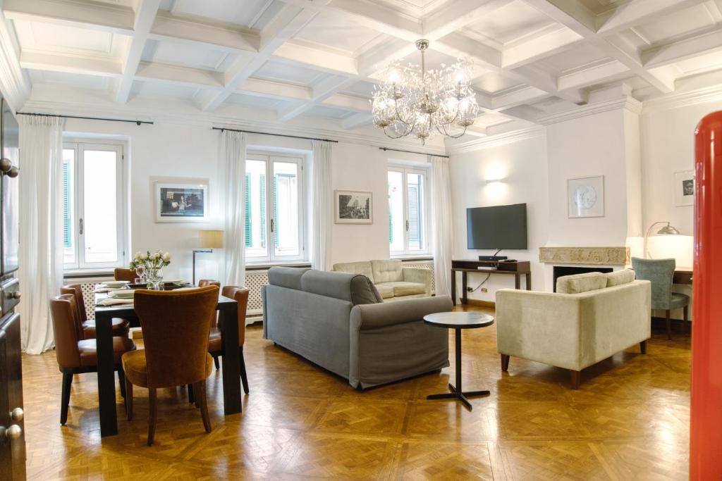 a living room with a couch and chairs and a television at Orsoline Boutique Apartments - Best position in Rome in Rome