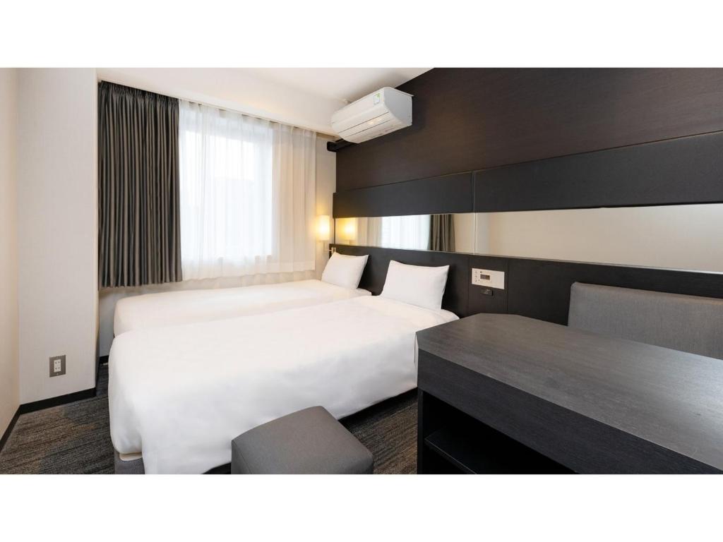 a hotel room with a bed and a desk at The OneFive Osaka Namba Dotonbori - Vacation STAY 51549v in Osaka
