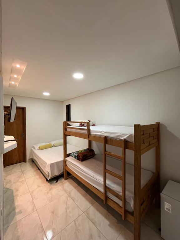 a room with two bunk beds in it at Sobrado para até 16 pessoas px ao centro in Porto De Galinhas