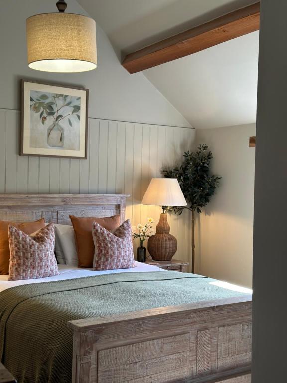 a bedroom with a large wooden bed with pillows at The Red Lion Inn Alnmouth in Alnmouth