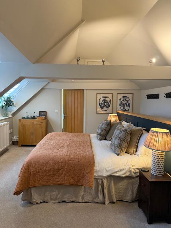 a bedroom with a large bed in a attic at The Red Lion Inn Alnmouth in Alnmouth
