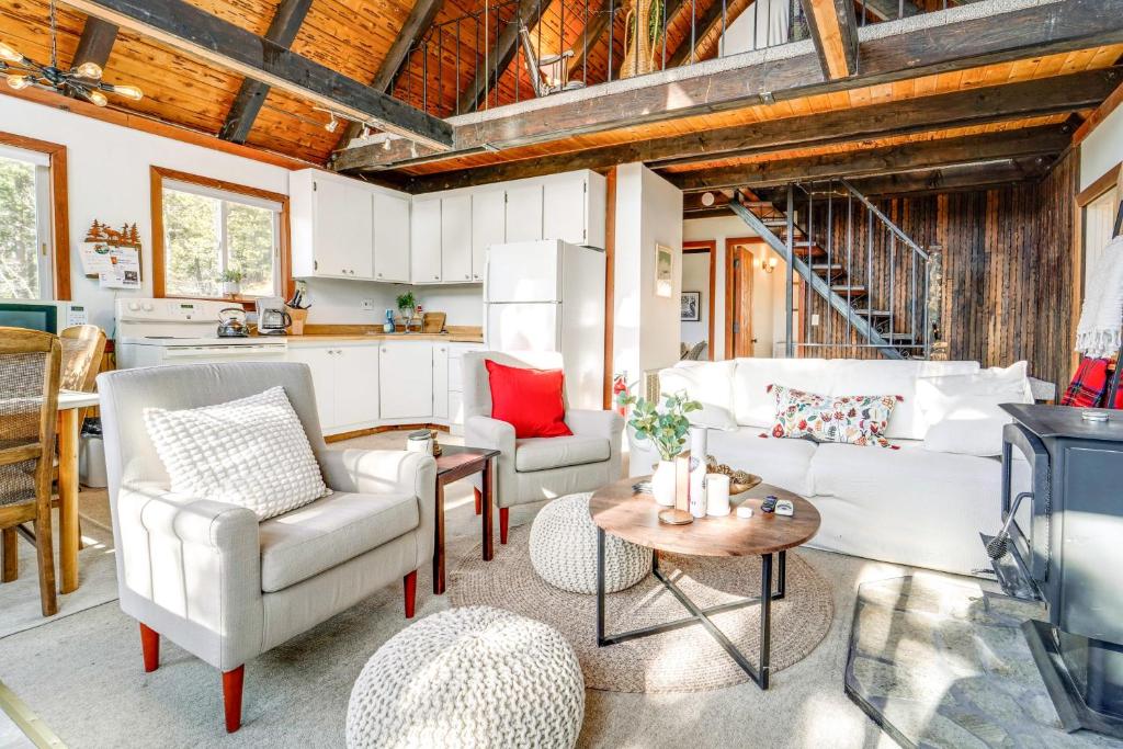 a living room with two chairs and a table at Serene Lakes Cabin with Deck Dog Friendly! in Soda Springs