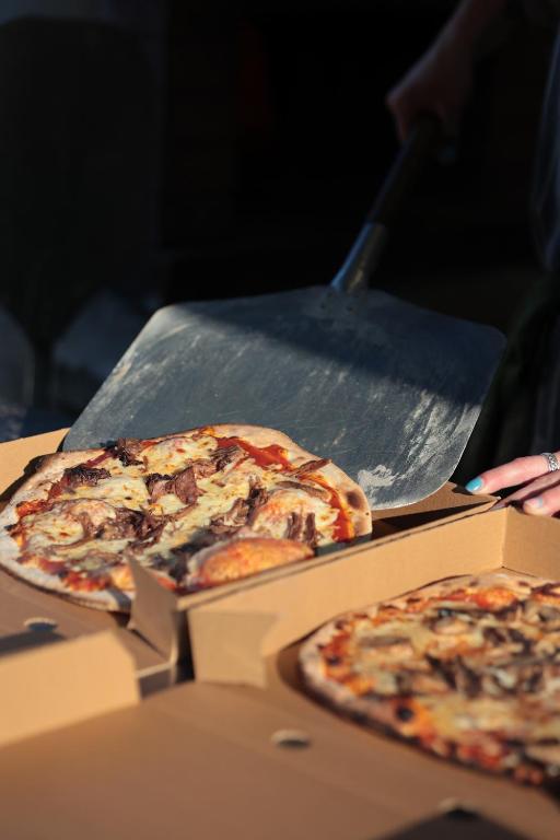 two pizzas sitting on top of a pizza pan at The Red Lion Inn Alnmouth in Alnmouth