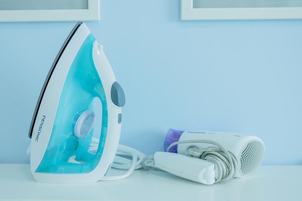 a computer monitor and a camera on a counter at Good Seaview, Vacation Home in Tanjong Tokong