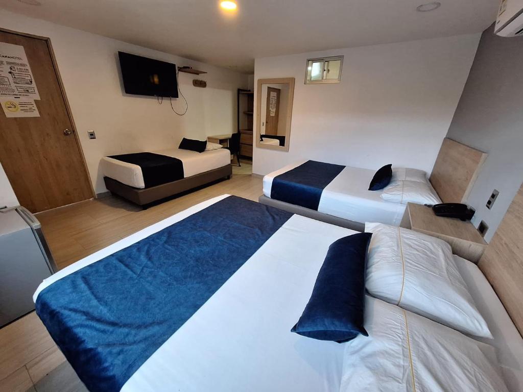 Postel nebo postele na pokoji v ubytování Hotel Suramericana