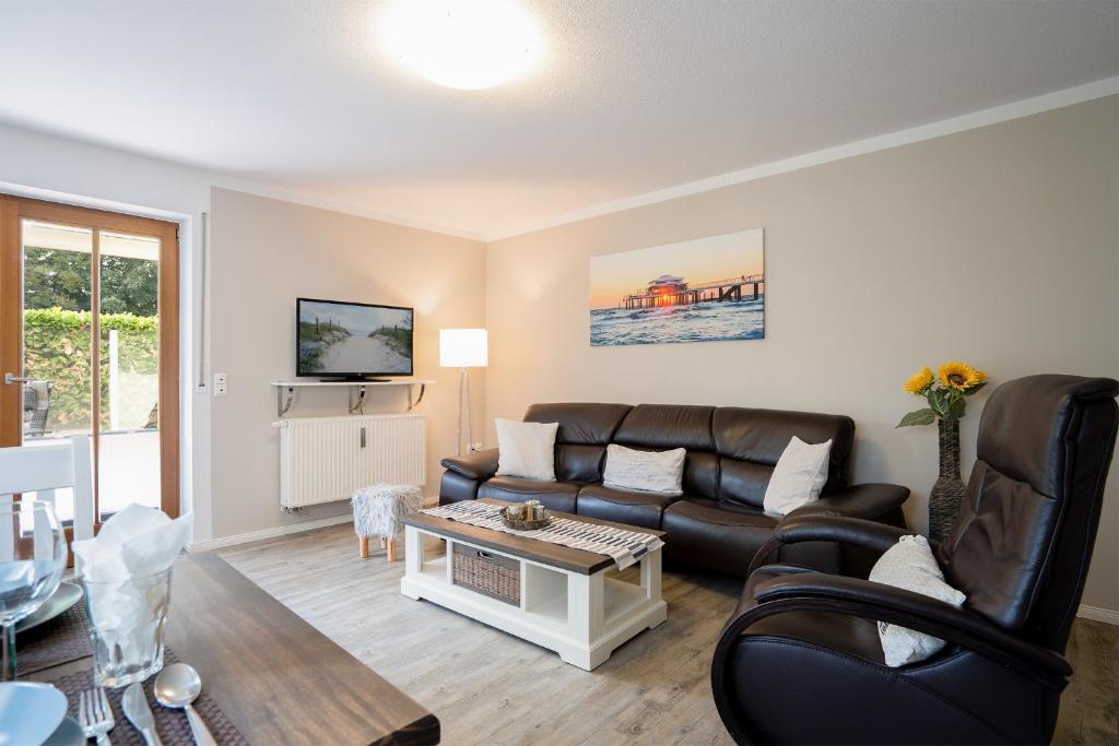 a living room with a couch and a table at Premium Quartier Solymar Pelzerhaken - ein kleiner Hund willkommen in Neustadt in Holstein