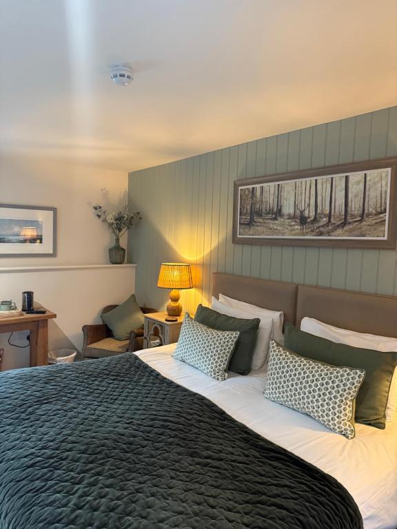 a bedroom with a large bed with two pillows at The Red Lion Inn Alnmouth in Alnmouth