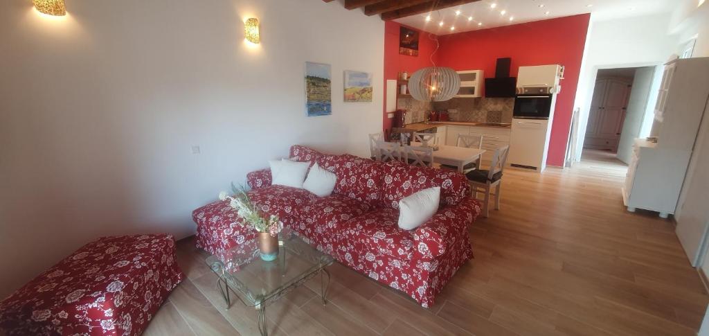 a living room with a red couch and a kitchen at Birkennest in Bingerbrück
