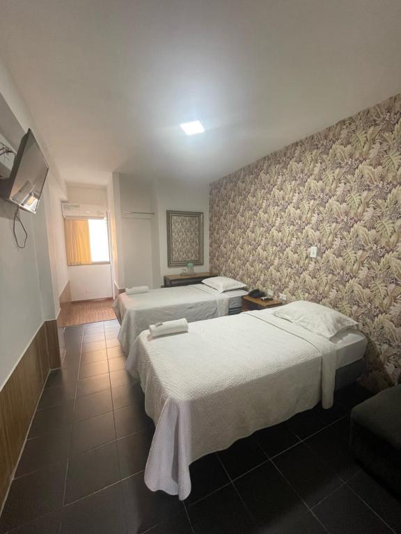 Postel nebo postele na pokoji v ubytování Hotel Costa Inn