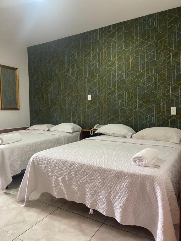 Postel nebo postele na pokoji v ubytování Hotel Costa Inn