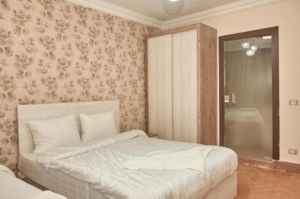 Postel nebo postele na pokoji v ubytování Grand Museum View Inn