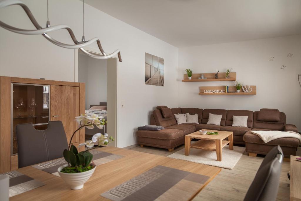 a living room with a couch and a table at Am Schlosspark in Bad Harzburg