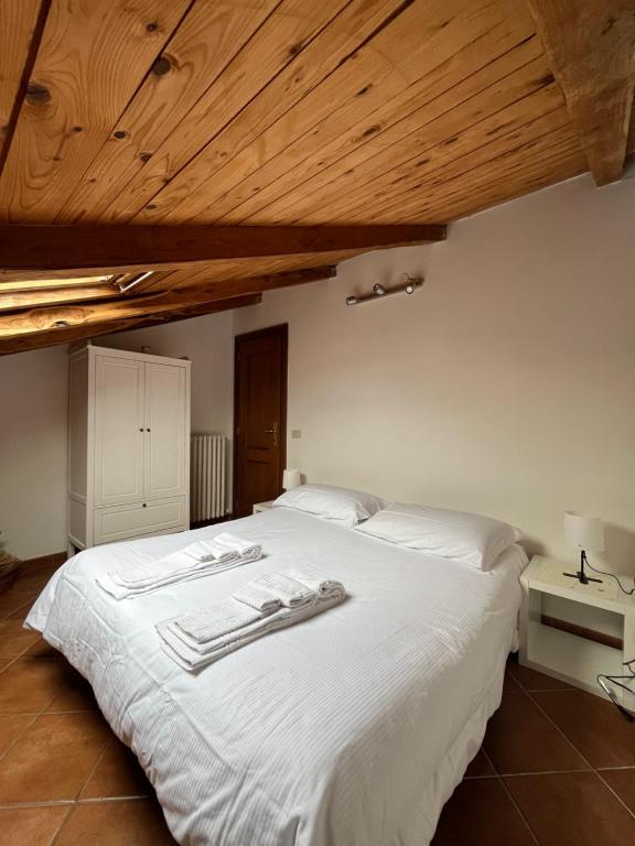a bedroom with a white bed with towels on it at A casa dei CHICCHI in Rome
