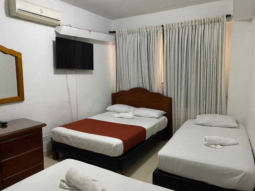 Postel nebo postele na pokoji v ubytování Hotel Laureles 70