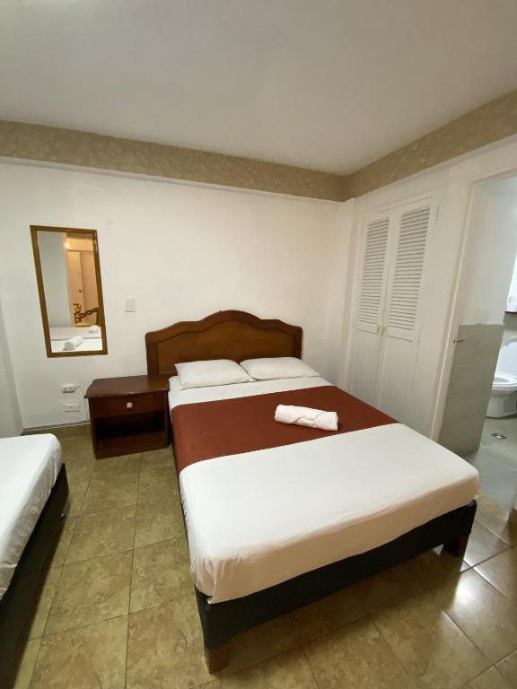 Postel nebo postele na pokoji v ubytování Hotel Laureles 70