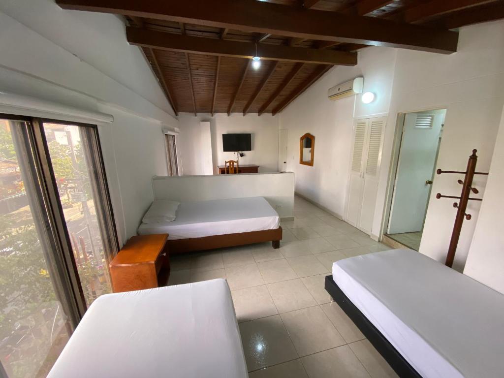 Postel nebo postele na pokoji v ubytování Hotel Laureles 70