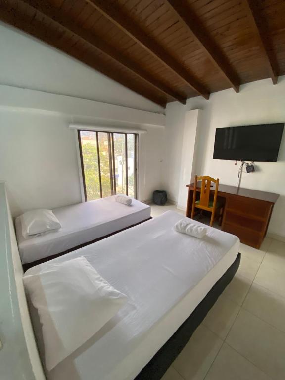 Postel nebo postele na pokoji v ubytování Hotel Laureles 70