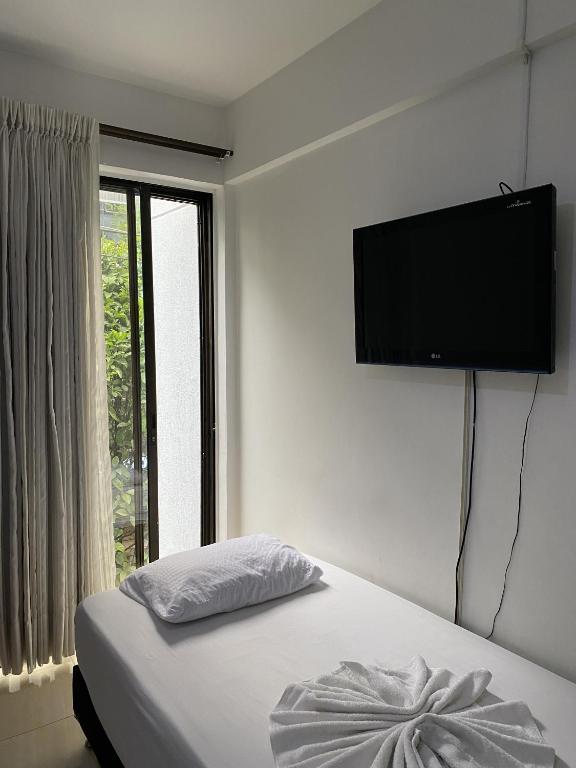 Postel nebo postele na pokoji v ubytování Hotel Laureles 70