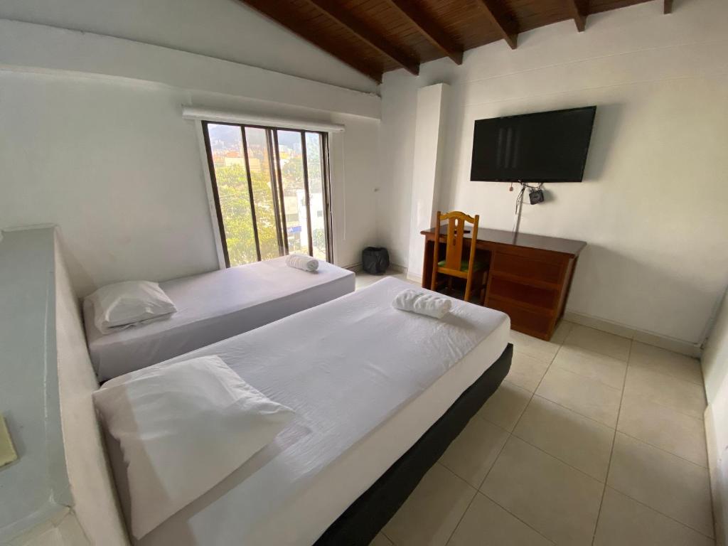 Postel nebo postele na pokoji v ubytování Hotel Laureles 70