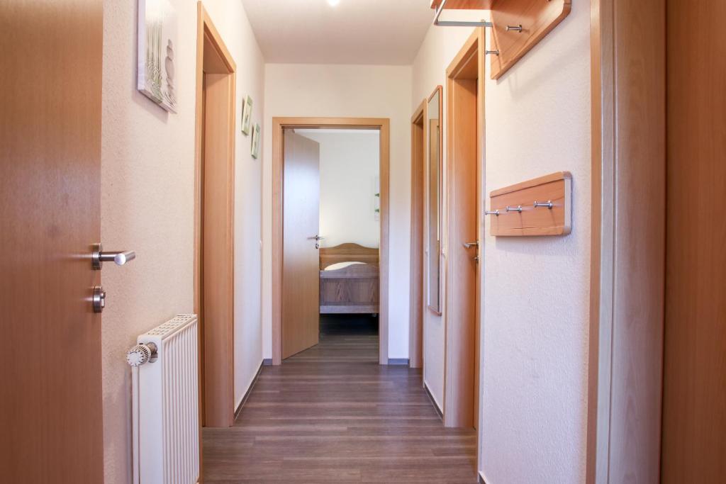 a corridor of a hallway with a room with a bed at Familienhof Brüning - Terrassenwohnung in Meppen
