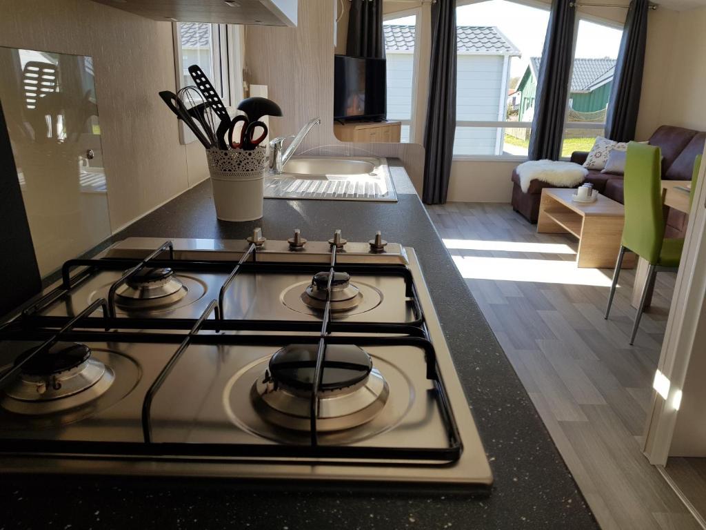a stove top oven sitting in a kitchen at Chalet Alpenstrandläufer am Kransburger See 543 in Kransburg