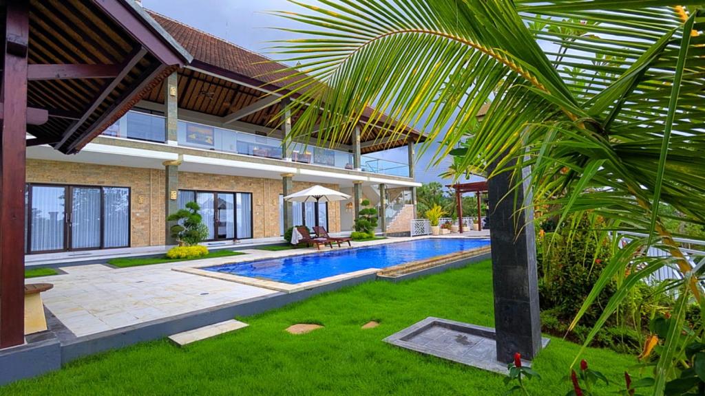 a house with a swimming pool in a yard at Luxurious, Seaview, Private Pool, 3-Bedroom Villa in Seraya in Seraya