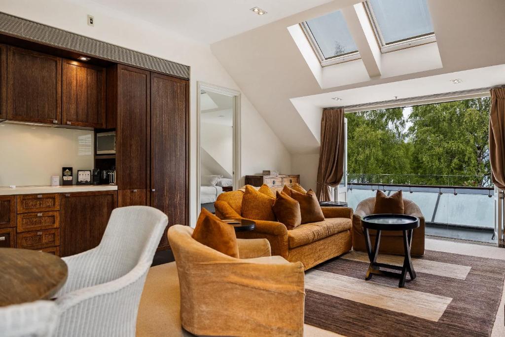 a living room with a couch and a table at Ben Lomond 2 -Top-floor lakeshore apartment in Queenstown