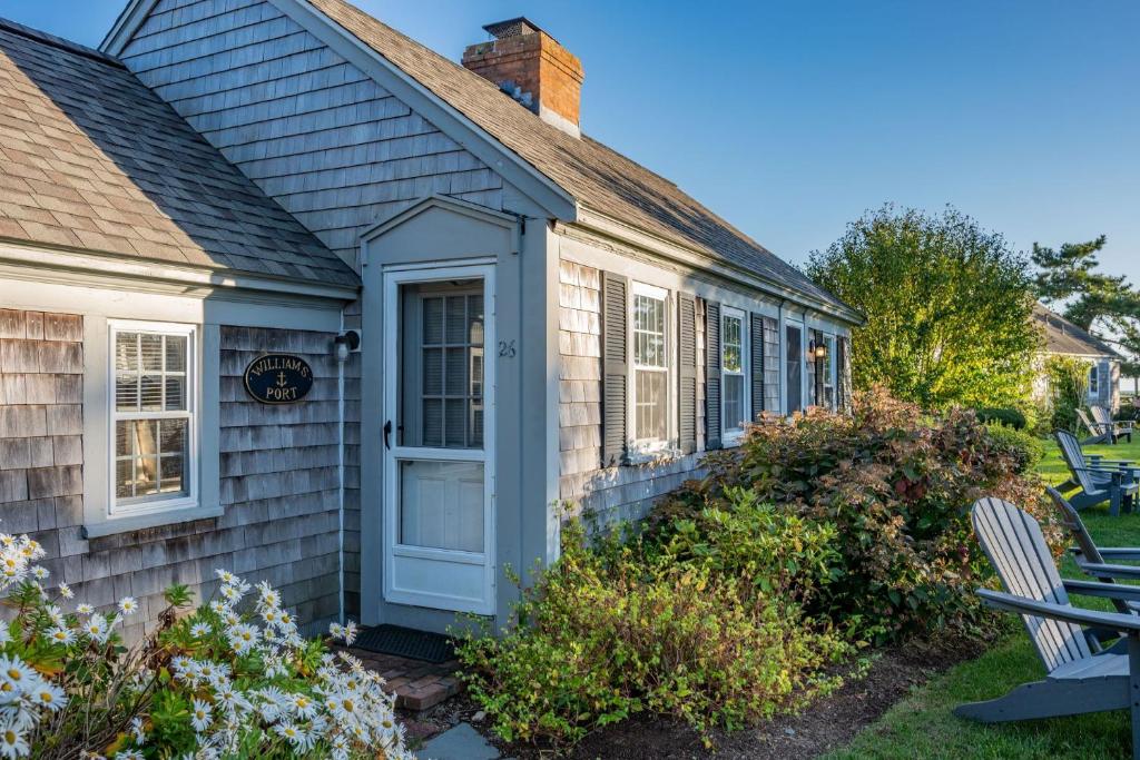 a house with a blue door and a yard at Seaside Cottages - Cottage 26 - Williams Port in South Yarmouth