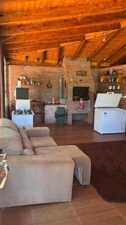 a large living room with two beds and a kitchen at Sítio das pedras in Ijuí
