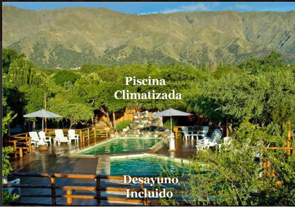 a view of a swimming pool with mountains in the background at Rincón de los Troncos in Merlo