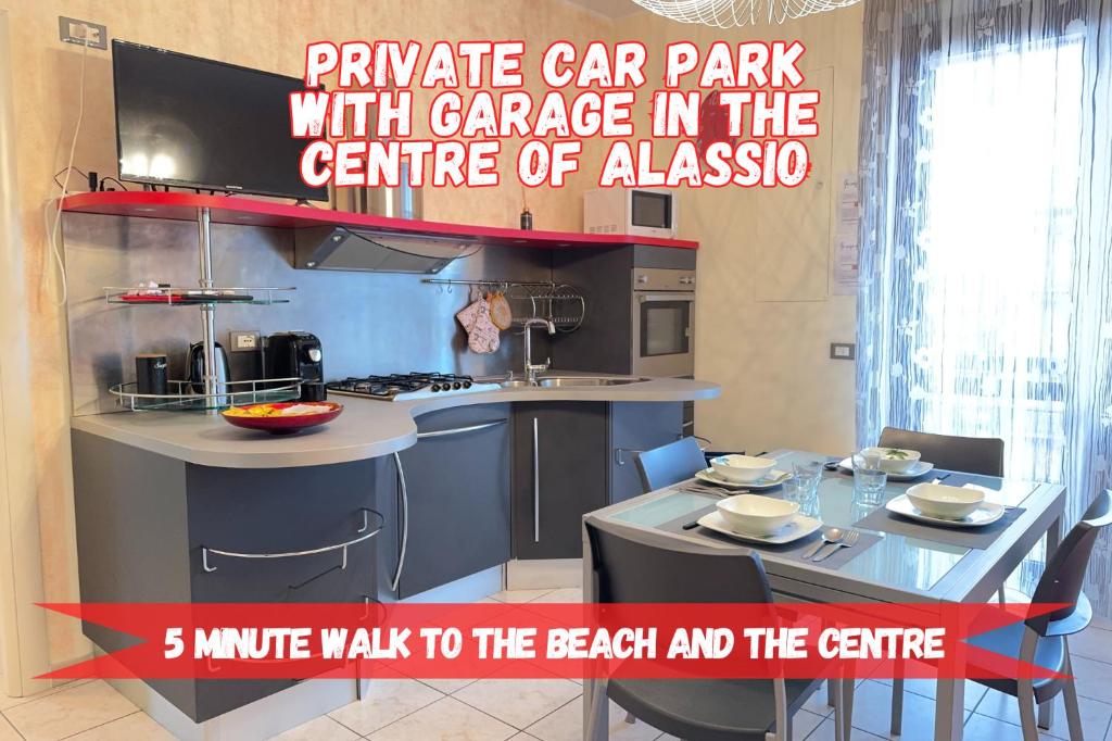 a kitchen with a table and a kitchen with a sign at Private Garage, 300m from Sea in Alassio Centre in Alassio