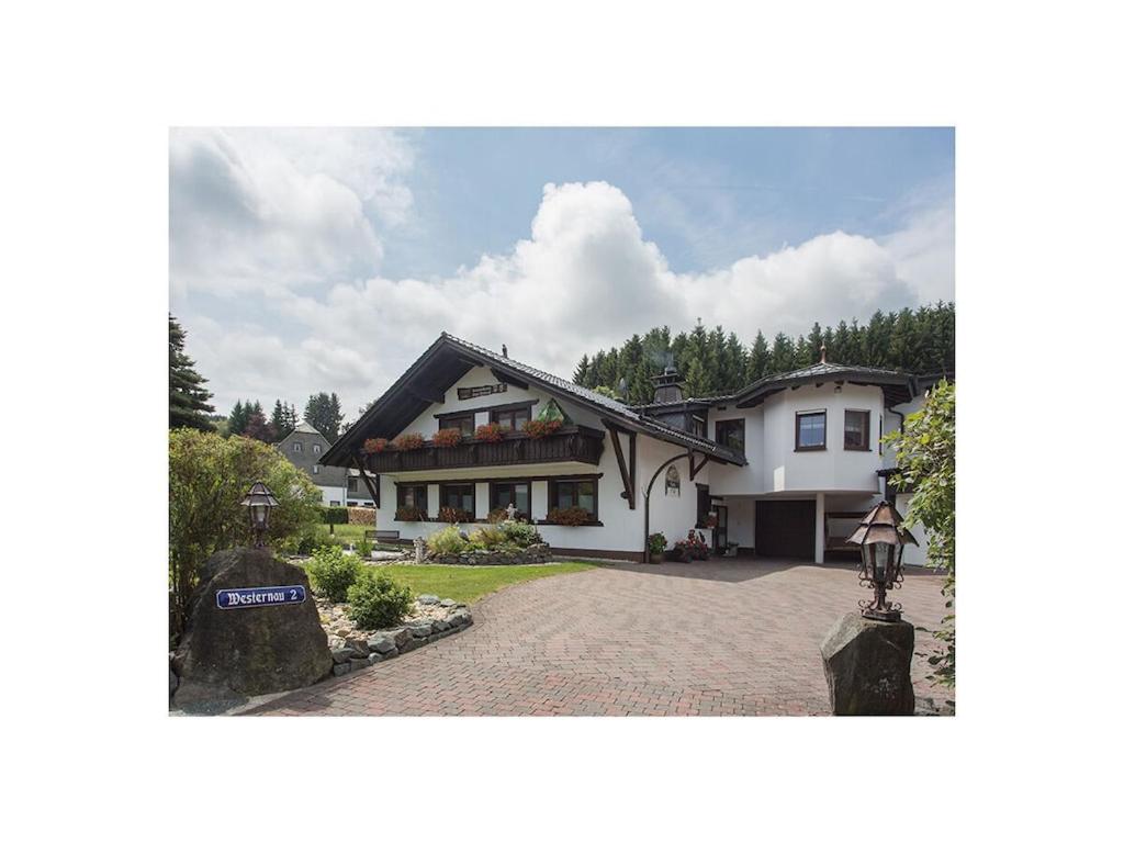 a large white house with a driveway at Haus Edelweiss Comfortable holiday residence in Winterberg