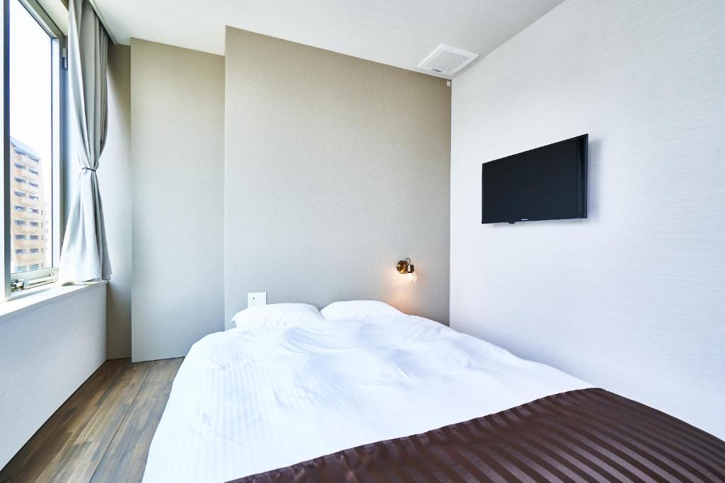 Postel nebo postele na pokoji v ubytování &AND HOSTEL HOMMACHI EAST