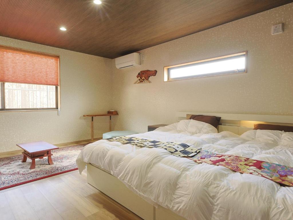 Postel nebo postele na pokoji v ubytování 籠屋mizunotoオーベルジュ