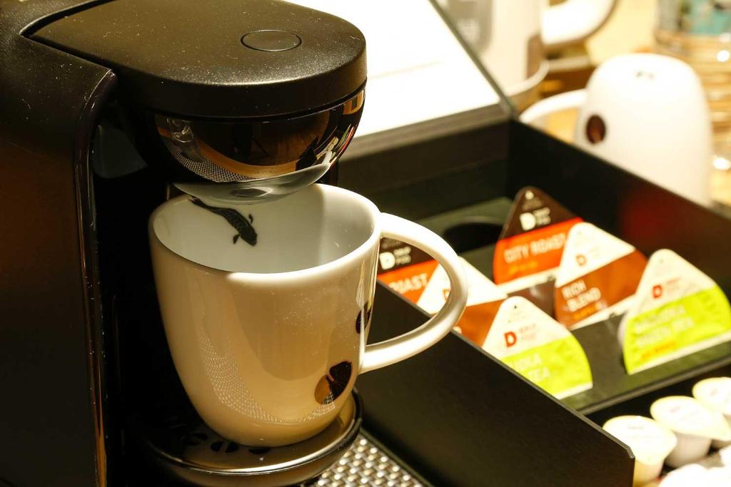 a coffee maker sitting on top of a coffee cup at Yuraku Kinosaki Spa & Gardens in Toyooka