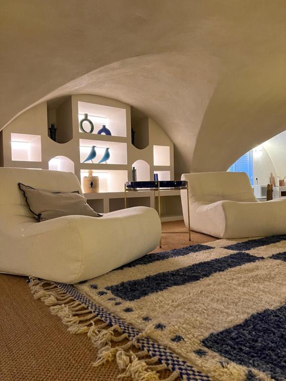 - un salon avec deux canapés blancs et un tapis dans l'établissement 60 m2 Dar blue Centre Historique Clermont-Ferrand Cathédrale, à Clermont-Ferrand