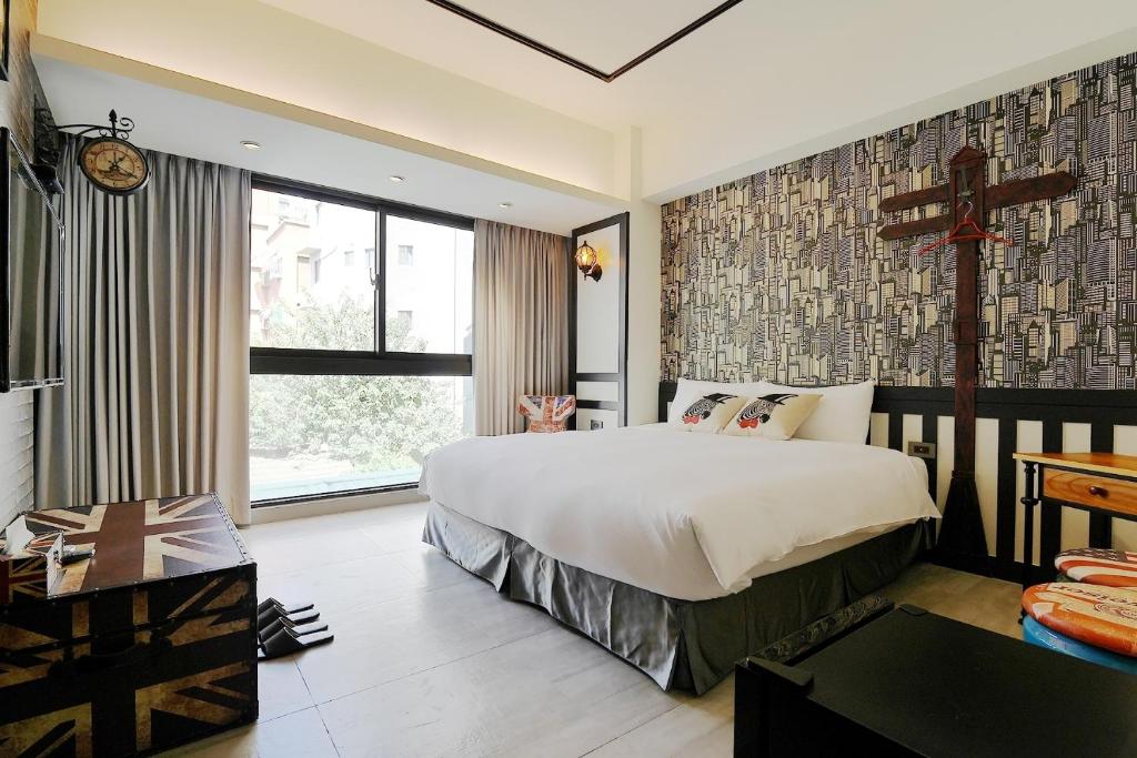 Postel nebo postele na pokoji v ubytování 默臨文旅 台中逢甲館 Morning INN