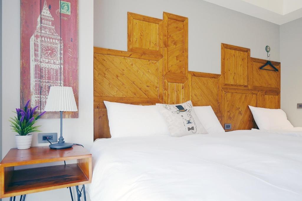 Postel nebo postele na pokoji v ubytování 默臨文旅 台中逢甲館 Morning INN