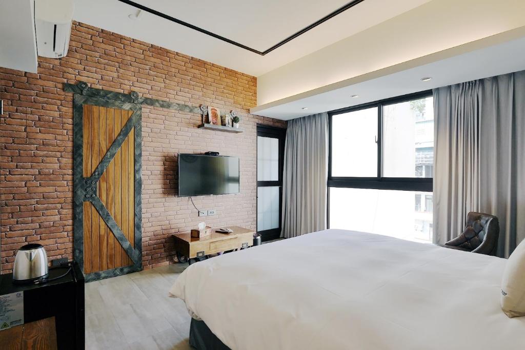 Postel nebo postele na pokoji v ubytování 默臨文旅 台中逢甲館 Morning INN