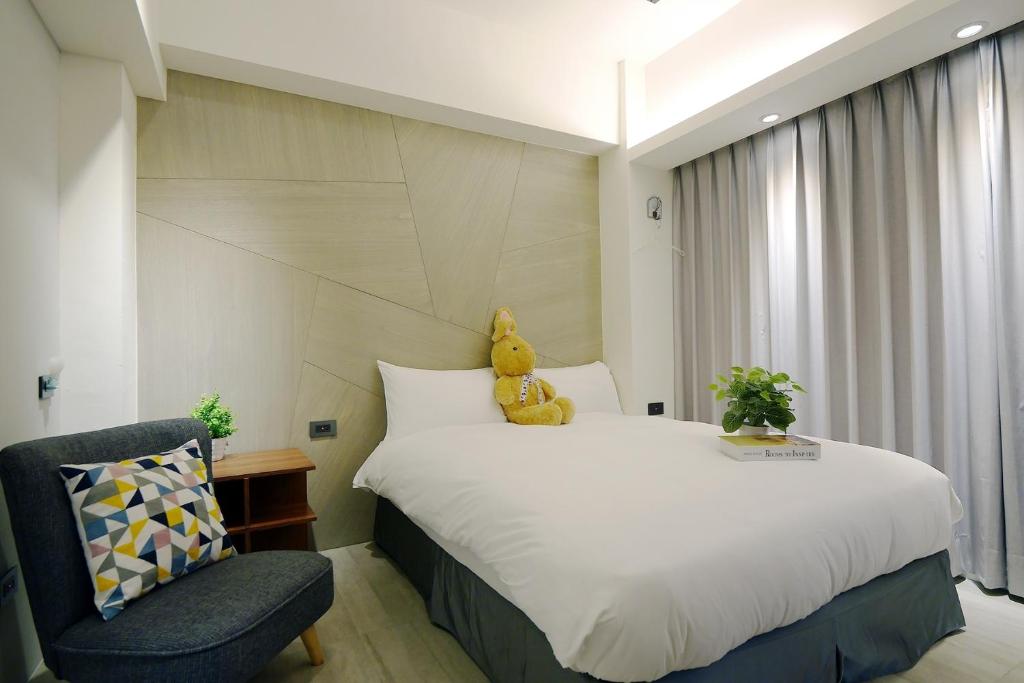 Postel nebo postele na pokoji v ubytování 默臨文旅 台中逢甲館 Morning INN