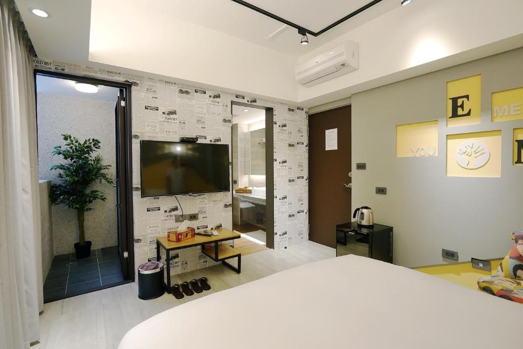 Postel nebo postele na pokoji v ubytování 默臨文旅 台中逢甲館 Morning INN